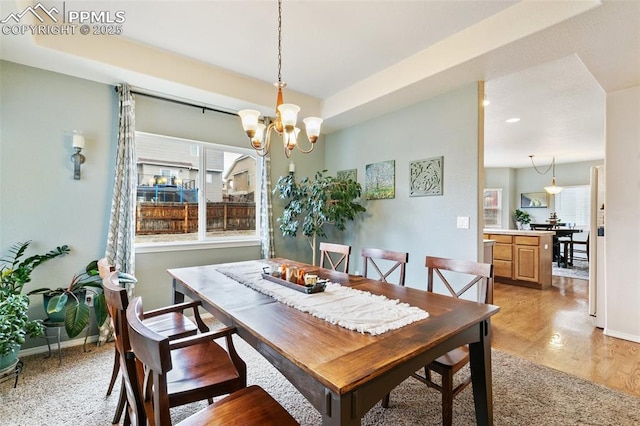 dining room with an inviting chandelier and light hardwood / wood-style flooring