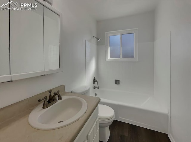 full bathroom featuring vanity, hardwood / wood-style floors, shower / bathtub combination, and toilet