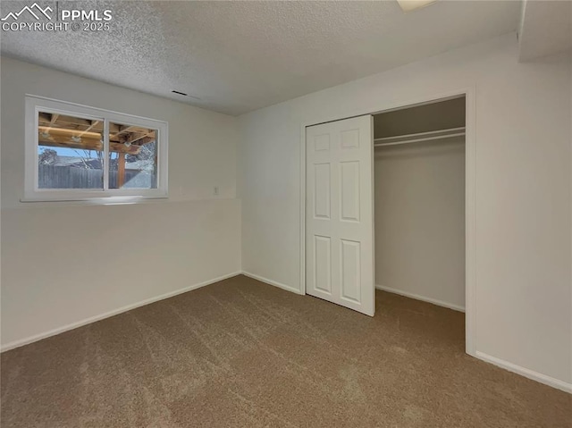 unfurnished bedroom featuring a closet, carpet flooring, and a textured ceiling