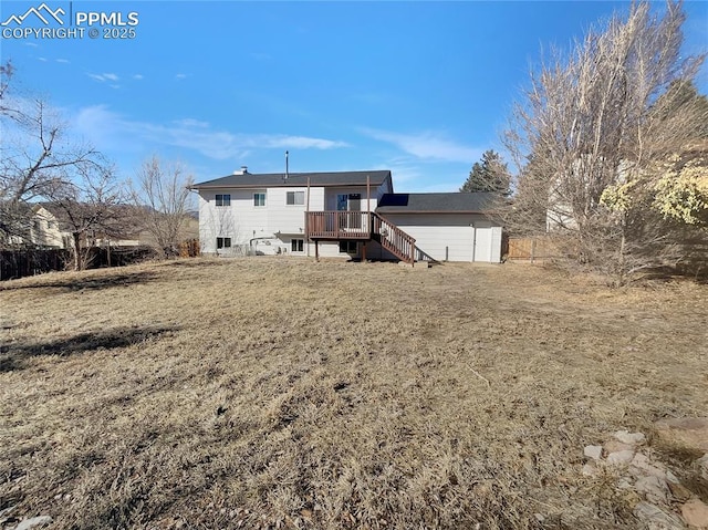 back of property featuring a yard and a deck