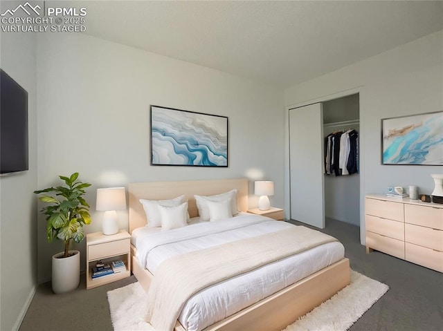 bedroom with a closet and dark colored carpet