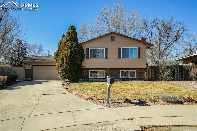 split level home featuring a garage and a front yard