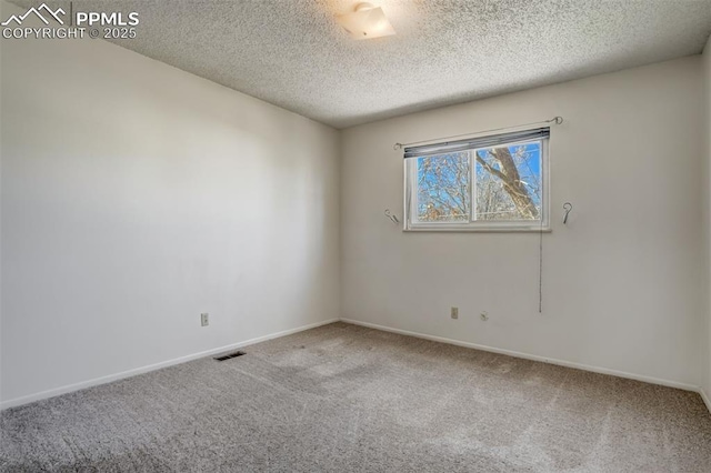 carpeted spare room with a textured ceiling