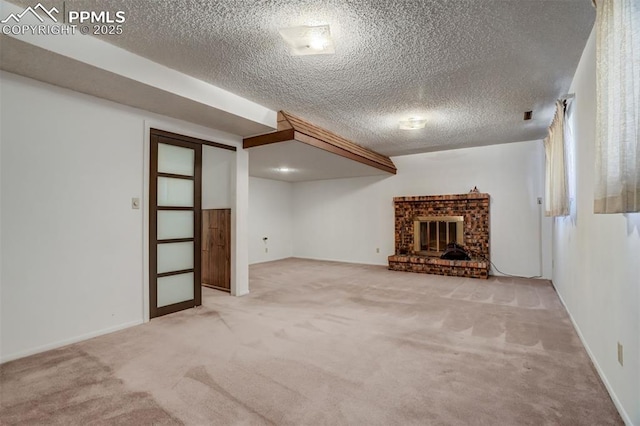 unfurnished living room with light colored carpet, a brick fireplace, and a textured ceiling