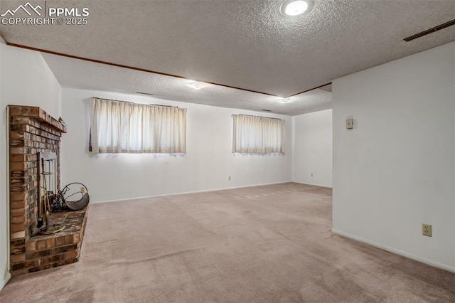 unfurnished living room with carpet flooring, a textured ceiling, and a fireplace