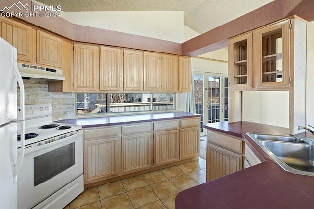 kitchen featuring lofted ceiling, sink, light tile patterned floors, light brown cabinets, and white appliances