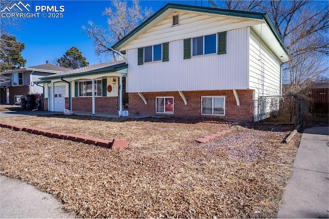 tri-level home featuring a garage and covered porch