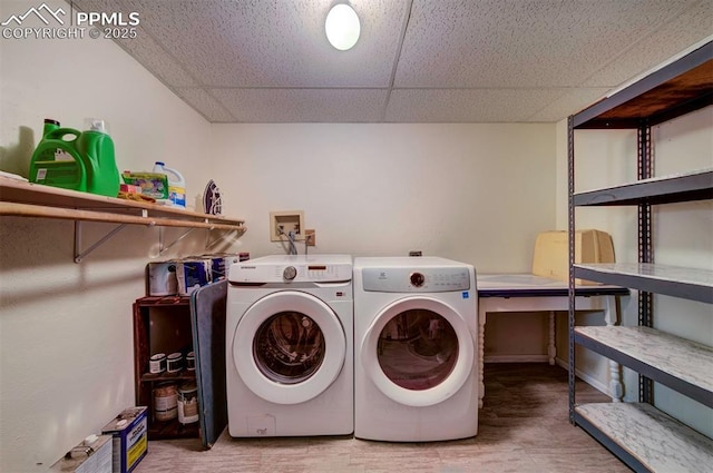 washroom with wood-type flooring and separate washer and dryer