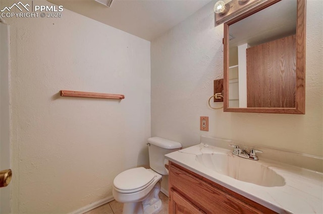 bathroom with vanity, tile patterned flooring, and toilet