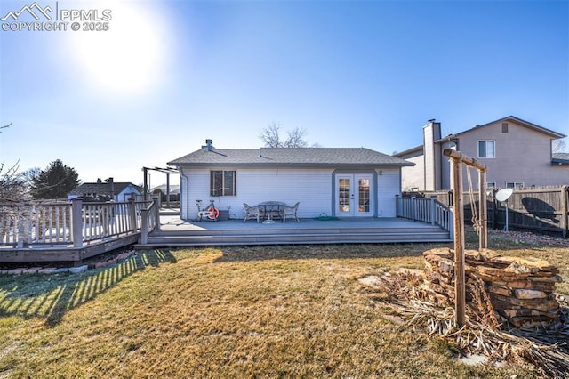 back of property with french doors, a lawn, a deck, and a pergola