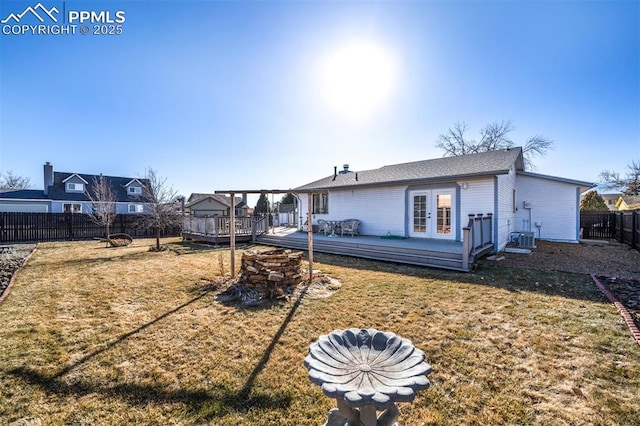 rear view of property featuring a wooden deck, a yard, central AC unit, and french doors