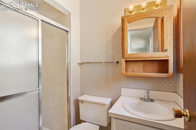 bathroom with toilet, vanity, and an enclosed shower