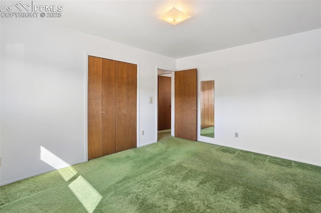 unfurnished bedroom featuring a closet and carpet flooring