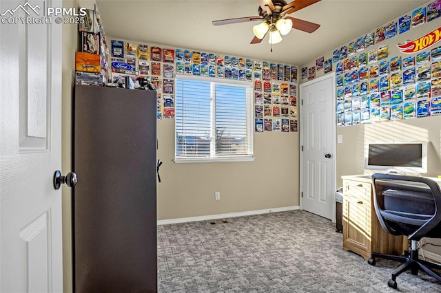 carpeted office space featuring ceiling fan