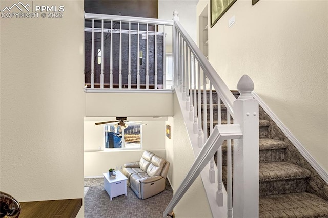 stairs with a high ceiling, carpet, a wealth of natural light, and ceiling fan