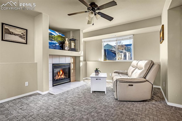 unfurnished room featuring ceiling fan, carpet, and a tile fireplace