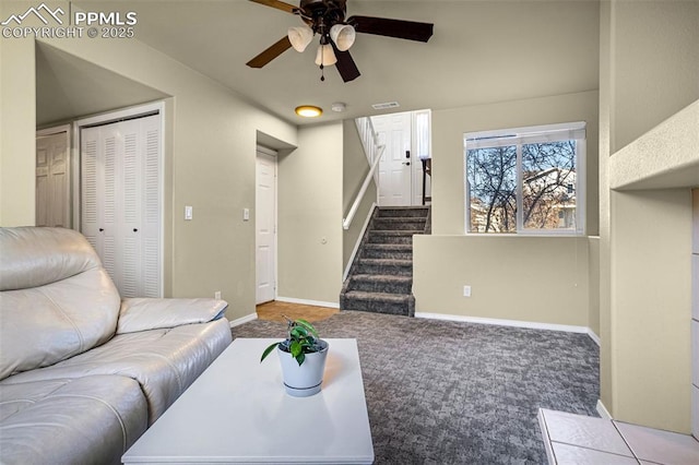 carpeted living room with ceiling fan