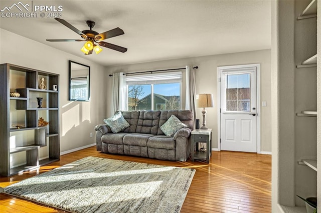 living room featuring hardwood / wood-style floors and ceiling fan