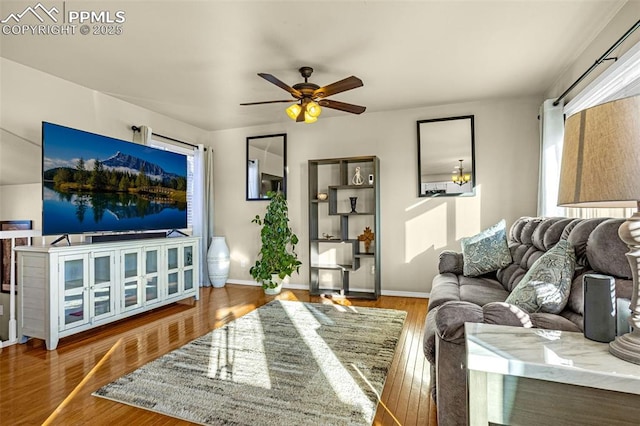 living room with hardwood / wood-style flooring and ceiling fan