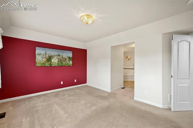 unfurnished room with light carpet