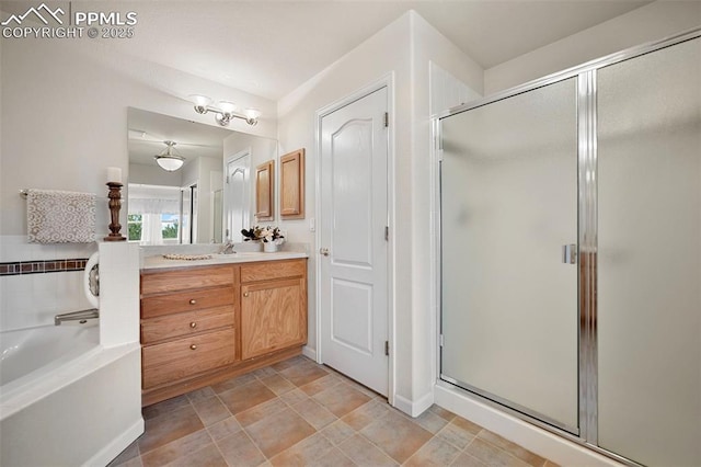 bathroom with vanity and independent shower and bath