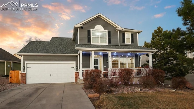 view of front of home with a garage and a porch