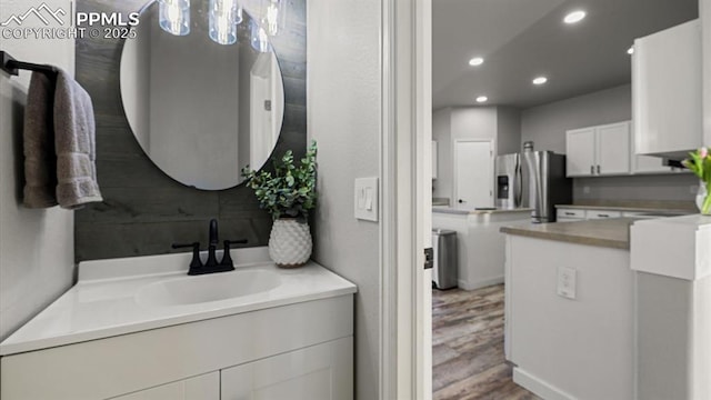 bathroom with vanity and hardwood / wood-style floors