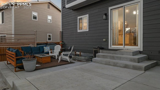 view of patio with an outdoor living space with a fire pit