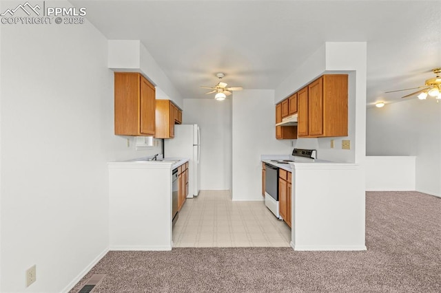 kitchen featuring a ceiling fan, range with electric cooktop, light countertops, light colored carpet, and under cabinet range hood