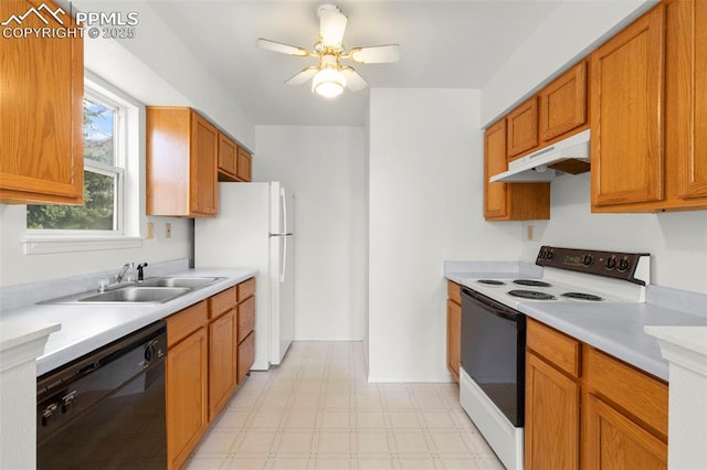 kitchen featuring a sink, white appliances, light floors, light countertops, and under cabinet range hood