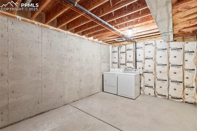 unfinished below grade area with washer and clothes dryer