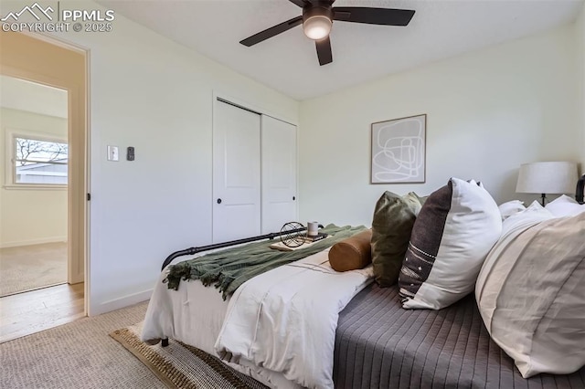 bedroom with light carpet, a closet, and ceiling fan