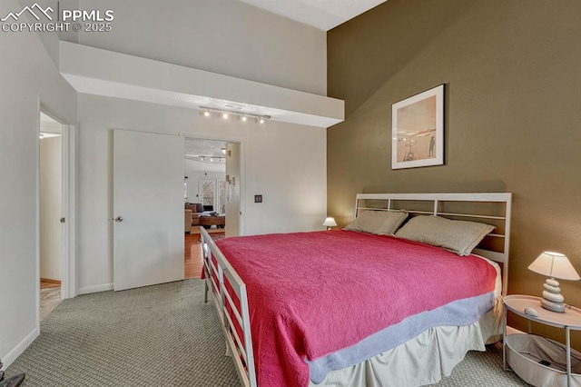 bedroom with baseboards and carpet flooring