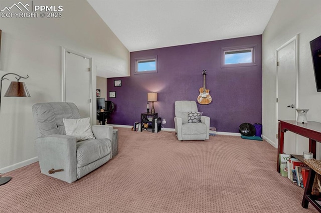 sitting room with carpet floors, high vaulted ceiling, and baseboards