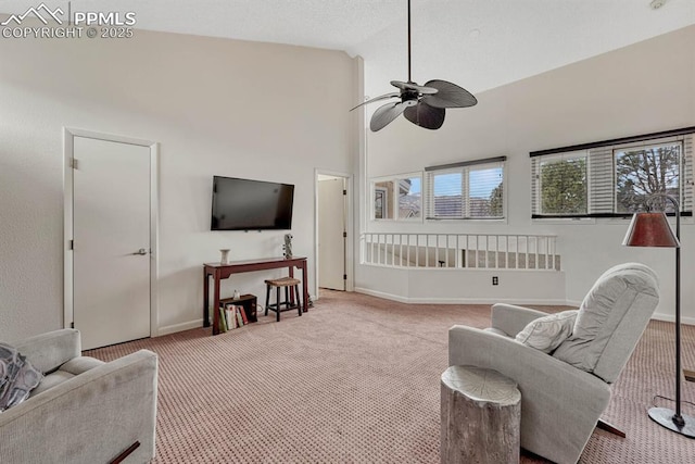 carpeted living area featuring high vaulted ceiling, baseboards, and a ceiling fan