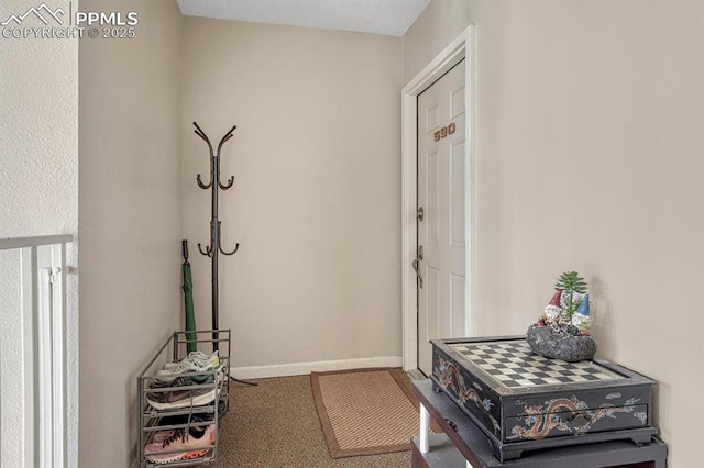 interior space featuring carpet floors and baseboards