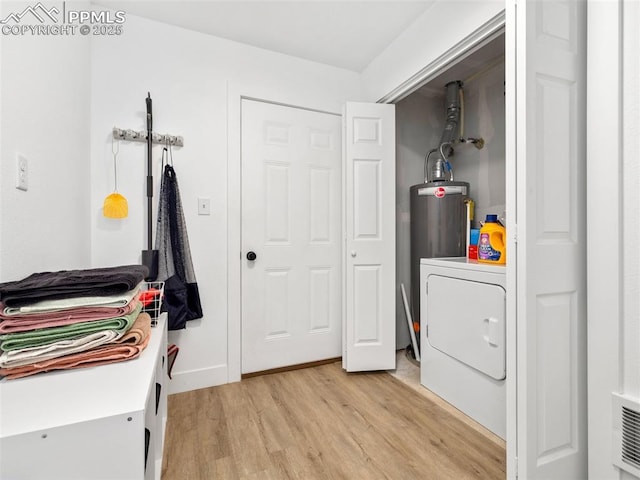 laundry room featuring light wood-type flooring and washer / dryer