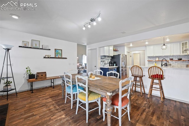 dining room featuring dark hardwood / wood-style floors and sink