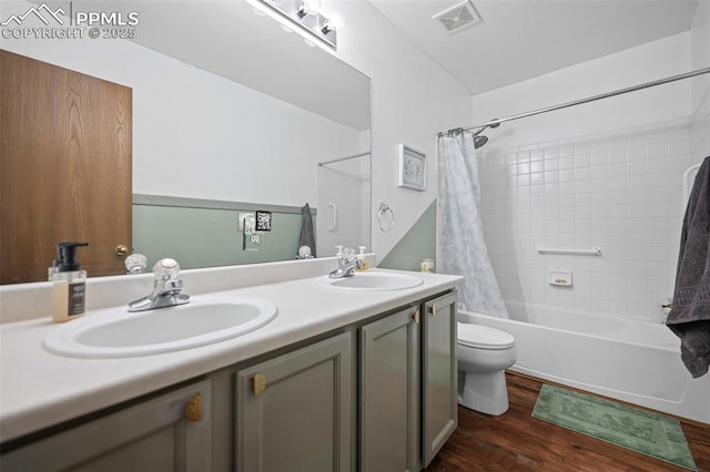 full bathroom featuring vanity, hardwood / wood-style floors, toilet, and shower / bath combo with shower curtain