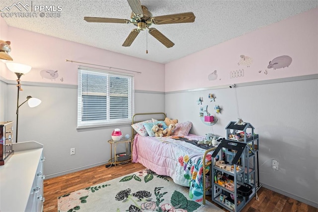 bedroom with ceiling fan, dark hardwood / wood-style floors, and a textured ceiling