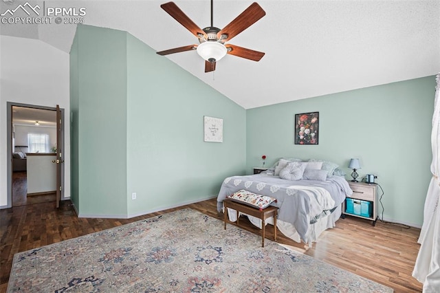 bedroom featuring hardwood / wood-style flooring, vaulted ceiling, and ceiling fan