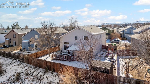 rear view of property with a wooden deck