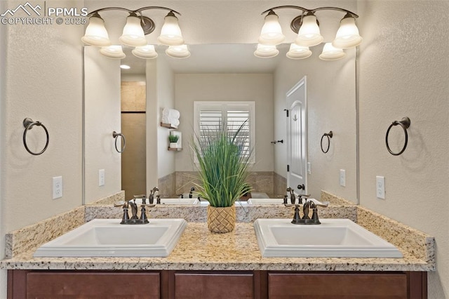 bathroom with a sink and double vanity