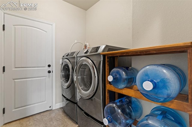 washroom featuring laundry area, washer and dryer, and tile patterned floors