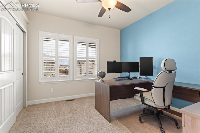 carpeted home office featuring a ceiling fan, visible vents, and baseboards