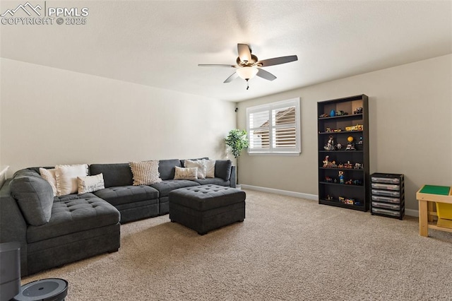 carpeted living area featuring ceiling fan and baseboards