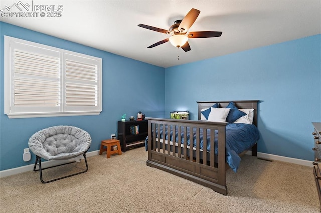 carpeted bedroom with ceiling fan and baseboards