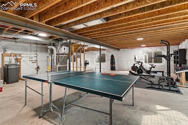 playroom with concrete flooring and gas water heater