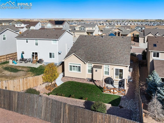 exterior space with a residential view, a fenced backyard, and a patio