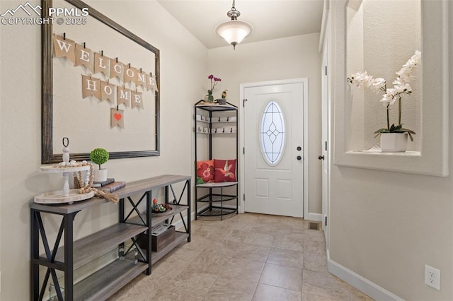 entryway featuring tile patterned floors, visible vents, and baseboards